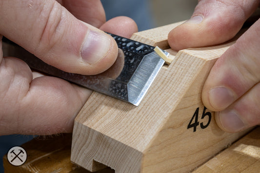 Sharp chisel paring a kumiko stick using a kumiko guide block