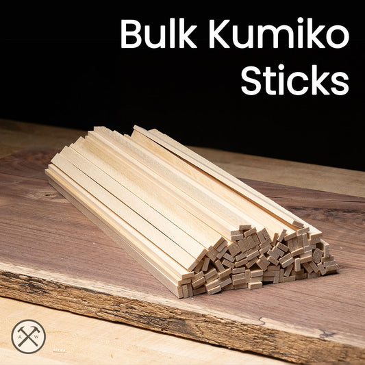 Stack of wooden Kumiko sticks on a wooden surface with 'Bulk Kumiko Sticks' text above.